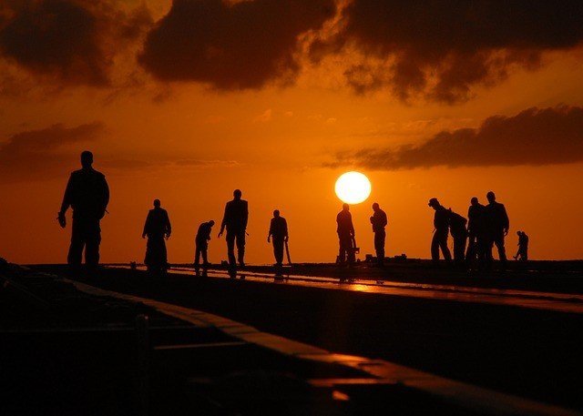 A group of people standing in front of a sunset - which of them do you want to speak to through social media marketing?